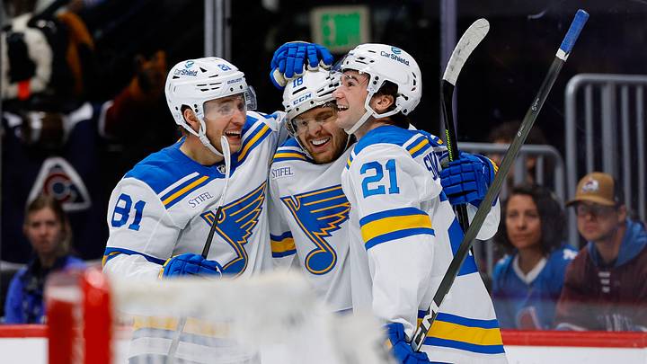 Apr 5, 2026; Denver, Colorado, USA; St. Louis Blues center Robert Thomas (18) celebrates his third goal of the game with left wing Dylan Holloway (81) and right wing Jimmy Snuggerud (21) in the third period against the Colorado Avalanche at Ball Arena. Mandatory Credit: Isaiah J. Downing-Imagn Images