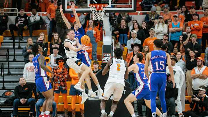 Jan 16, 2024; Stillwater, Oklahoma, USA; Oklahoma State Cowboys guard Connor Dow (13) collides with Kansas Jayhawks guard Johnny Furphy (10) under the basket during the second half at Gallagher-Iba Arena. Mandatory Credit: William Purnell-Imagn Images Jan 16, 2024; Stillwater, Oklahoma, USA; Oklahoma State Cowboys guard Connor Dow (13) collides with Kansas Jayhawks guard Johnny Furphy (10) under the basket during the second half at Gallagher-Iba Arena. Mandatory Credit: William Purnell-Imagn Images