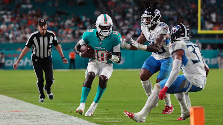 Tennessee Titans linebacker James Williams (52) forces Miami Dolphins quarterback Tyler Huntley (18) out of bounds during the second half at Hard Rock Stadium.