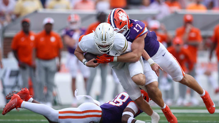 Sep 13, 2025; Atlanta, Georgia, USA; Georgia Tech Yellow Jackets quarterback Haynes King (10) is tackled by Clemson Tigers linebacker Wade Woodaz (17) in the third quarter at Bobby Dodd Stadium at Hyundai Field. Mandatory Credit: Brett Davis-Imagn Images