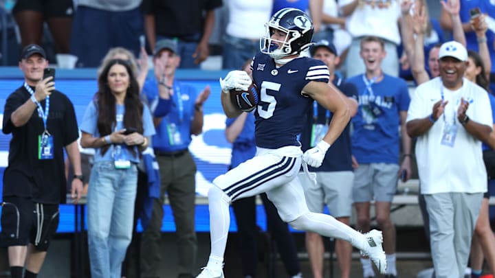 Aug 30, 2025; Provo, Utah, USA; Brigham Young Cougars wide receiver Cody Hagen (5) runs for a touchdown against the Portland State Vikings during the second quarter at LaVell Edwards Stadium. Mandatory Credit: Rob Gray-Imagn Images