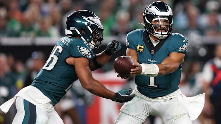 Sep 4, 2025; Philadelphia, Pennsylvania, USA; Philadelphia Eagles quarterback Jalen Hurts (1) hands off the ball to running back Saquon Barkley (26) during the third quarter of the game against the Dallas Cowboys at Lincoln Financial Field. 