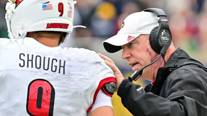 Sep 28, 2024; South Bend, Indiana, USA; Louisville Cardinals head coach Jeff Brohm talks to quarterback Tyler Shough (9) in the second quarter against the Notre Dame Fighting Irish at Notre Dame Stadium. Mandatory Credit: Matt Cashore-Imagn Images