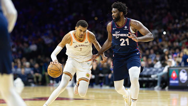 Jan 22, 2024; Philadelphia, Pennsylvania, USA; San Antonio Spurs center Victor Wembanyama (1) dribbles the ball against Philadelphia 76ers center Joel Embiid (21) during the third quarter at Wells Fargo Center. Mandatory Credit: Bill Streicher-Imagn Images Jan 22, 2024; Philadelphia, Pennsylvania, USA; San Antonio Spurs center Victor Wembanyama (1) dribbles the ball against Philadelphia 76ers center Joel Embiid (21) during the third quarter at Wells Fargo Center. Mandatory Credit: Bill Streicher-Imagn Images