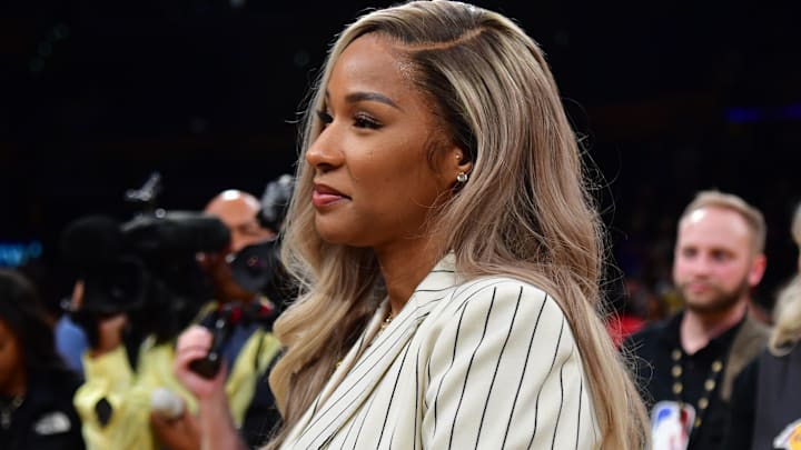 Savannah James watches her husband Los Angeles Lakers forward LeBron James (6) answer questions from media on court after the game against the Oklahoma City Thunder at Crypto.com Arena.