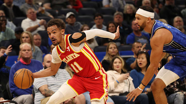 Atlanta Hawks guard Trae Young (11) drives to the basket as  Orlando Magic guard Jalen Suggs (4) defends during the first quarter at Kia Center.