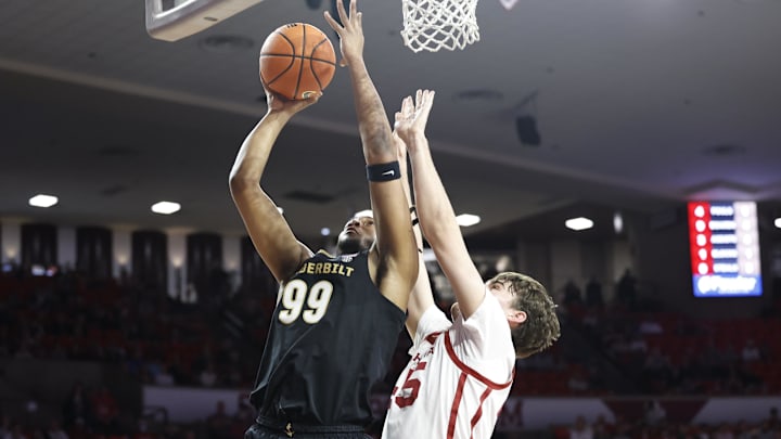Feb 1, 2025; Norman, Oklahoma, USA; Vanderbilt Commodores forward Devin McGlockton (99) shoots the ball against Oklahoma Sooners forward Luke Northweather (45) during the first half at Lloyd Noble Center. Mandatory Credit: Alonzo Adams-Imagn Images