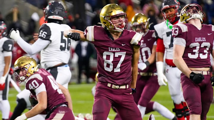 Bishop Watterson's Jack Schuler (87) celebrates after CJ Youell (40) got a sack against Toledo Central Catholic in the second half of the Division III State Championship game at Tom Benson Hall of Fame Stadium on Friday, Dec. 6, 2024 in Canton, Ohio.