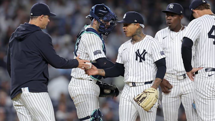 Sep 25, 2024; Bronx, New York, USA; New York Yankees manager Aaron Boone (17) takes the ball from starting pitcher Marcus Stroman (0) during the fourth inning against the Baltimore Orioles at Yankee Stadium. Mandatory Credit: Brad Penner-Imagn Images