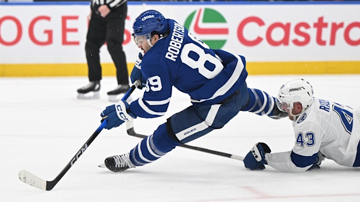 Mar 7, 2026; Toronto, Ontario, CAN;   Toronto Maple Leafs forward Nick Robertson (89) is tripped by Tampa Bay Lightning defenseman Darren Raddysh (43) in the first period at Scotiabank Arena. Mandatory Credit: Dan Hamilton-Imagn Images