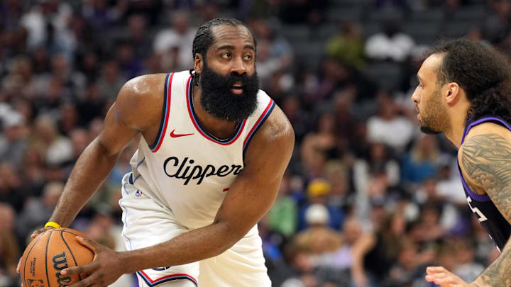 Apr 11, 2025; Sacramento, California, USA; Los Angeles Clippers guard James Harden (left) handles the ball against Sacramento Kings guard Devin Carter (right) during the fourth quarter at Golden 1 Center. Mandatory Credit: Darren Yamashita-Imagn Images