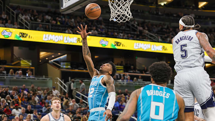 Feb 12, 2025; Orlando, Florida, USA; Charlotte Hornets guard Elfrid Payton (22) goes to the basket against Orlando Magic forward Paolo Banchero (5) during the first quarter at Kia Center. Mandatory Credit: Mike Watters-Imagn Images Feb 12, 2025; Orlando, Florida, USA; Charlotte Hornets guard Elfrid Payton (22) goes to the basket against Orlando Magic forward Paolo Banchero (5) during the first quarter at Kia Center. Mandatory Credit: Mike Watters-Imagn Images