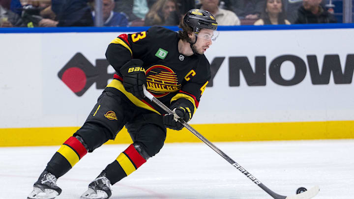 Jan 25, 2025; Vancouver, British Columbia, CAN; Vancouver Canucks defenseman Quinn Hughes (43) handles the puck against the Washington Capitals in the third period at Rogers Arena. Mandatory Credit: Bob Frid-Imagn Images