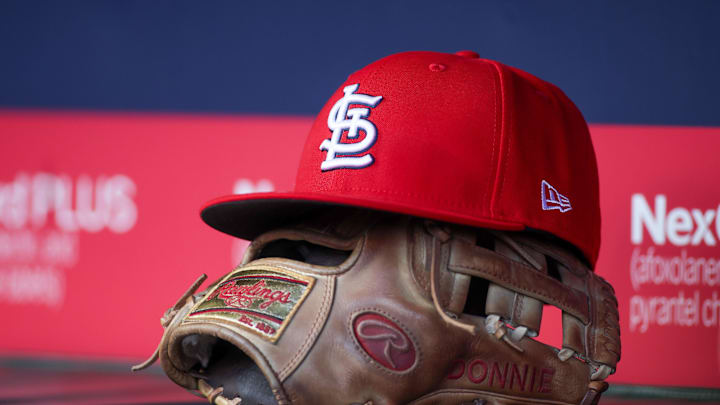 Apr 21, 2025; Atlanta, Georgia, USA; A St. Louis Cardinals hat and glove in the dugout against the Atlanta Braves in the first inning at Truist Park. Mandatory Credit: Brett Davis-Imagn Images Apr 21, 2025; Atlanta, Georgia, USA; A St. Louis Cardinals hat and glove in the dugout against the Atlanta Braves in the first inning at Truist Park. Mandatory Credit: Brett Davis-Imagn Images