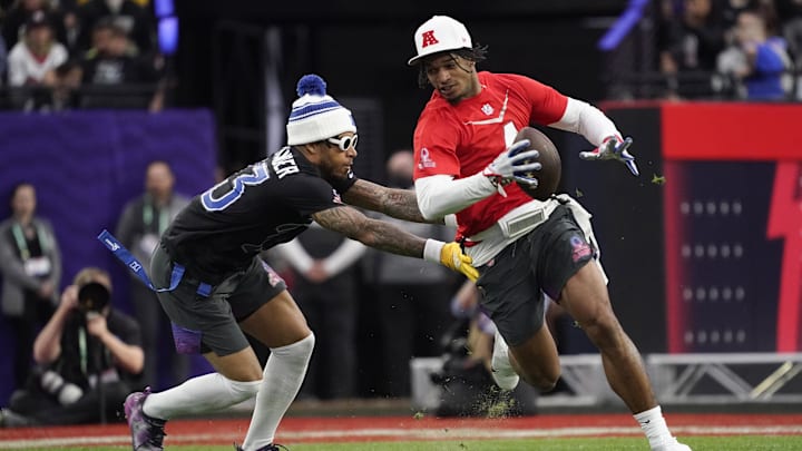 Feb 5, 2023; Paradise, Nevada, USA; AFC wide receiver Ja Marr Chase of the Cincinnati Bengals (1) runs the ball against NFC cornerback Jaire Alexander of the Green Bay Packers (23) at the 2023 Pro Bowl at Allegiant Stadium. Mandatory Credit: Lucas Peltier-Imagn Images