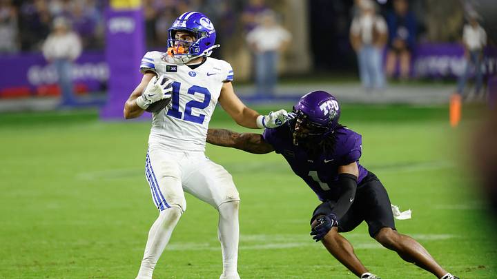 Oct 3, 2026; Fort Worth, Texas, USA;  BYU Cougars running back Preston Rex (12) runs after a catch against TCU Horned Frogs cornerback Vernon Glover, Jr. (1) during the second half at Amon G. Carter Stadium.  Mandatory Credit: Chris Jones-Imagn Images