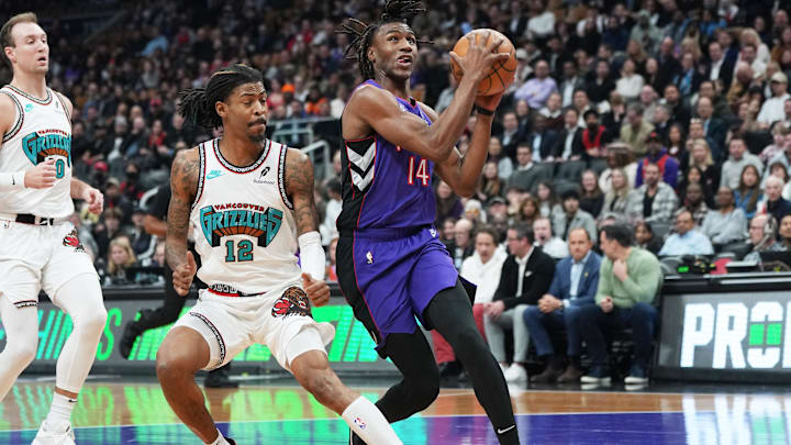 Feb 5, 2025; Toronto, Ontario, CAN; Toronto Raptors guard Ja'Kobe Walter (14) drives to the basket as Memphis Grizzlies guard Ja Morant (12) tries to defend during the first quarter at Scotiabank Arena. Mandatory Credit: Nick Turchiaro-Imagn Images