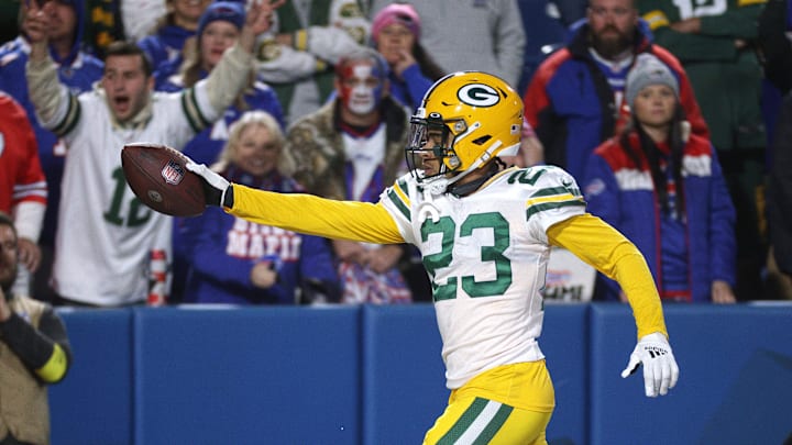 Packers cornerback Jaire Alexander gives the ball to a fan after his interception against the Bills.