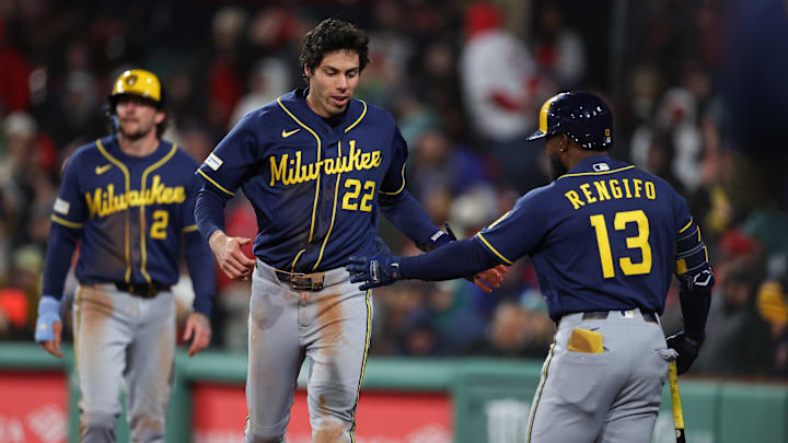Apr 6, 2026; Boston, Massachusetts, USA; Milwaukee Brewers left fielder Christian Yelich (22) celebrates with Milwaukee Brewers second baseman Luis Rengifo (13) during the eighth inning against the Boston Red Sox at Fenway Park. Mandatory Credit: Paul Rutherford-Imagn Images