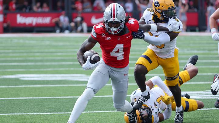 Sep 19, 2026; Columbus, Ohio, USA; Ohio State Buckeyes wide receiver Jeremiah Smith (4) runs after making the catch as Kent State Golden Flashes defensive back A'tiq Muhammad (1) makes the tackle during the first quarter at Ohio Stadium. Mandatory Credit: Joseph Maiorana-Imagn Images Sep 19, 2026; Columbus, Ohio, USA; Ohio State Buckeyes wide receiver Jeremiah Smith (4) runs after making the catch as Kent State Golden Flashes defensive back A'tiq Muhammad (1) makes the tackle during the first quarter at Ohio Stadium. Mandatory Credit: Joseph Maiorana-Imagn Images