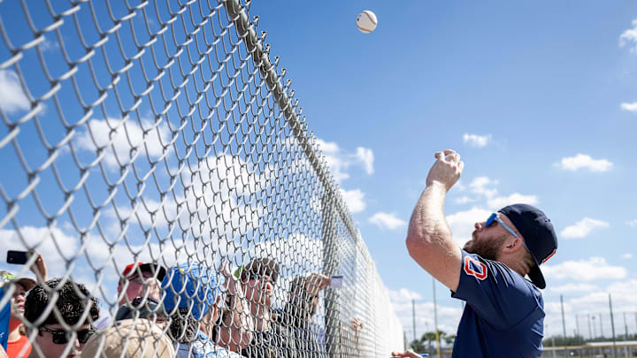 Feb 15, 2025; Lee County, FL, USA; Boston Red Sox shortstop Trevor Story (10) tosses an autographed ball to a young fan during spring training at JetBlue Park at Fenway South Credit  Chris Tilley-Imagn Images