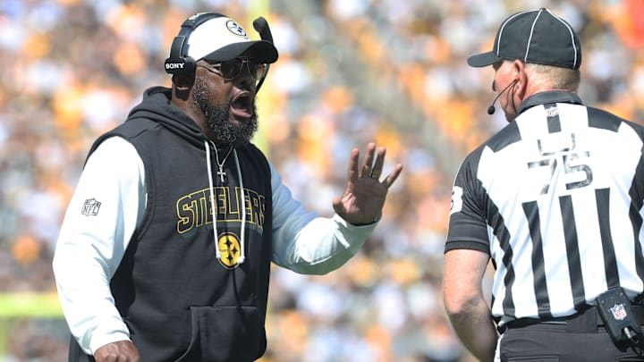 Sep 14, 2025; Pittsburgh, Pennsylvania, USA;  Pittsburgh Steelers head coach Mike Tomlin reacts on the sidelines to line judge Mark Stewart (75) against the Seattle Seahawks during the second quarter at Acrisure Stadium. Mandatory Credit: Charles LeClaire-Imagn Images
