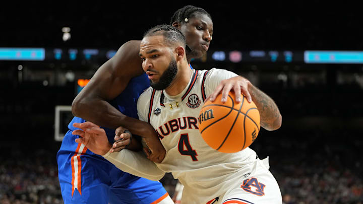 Apr 5, 2025; San Antonio, TX, USA; Auburn Tigers forward Johni Broome (4) drives to the basket against Florida Gators center Rueben Chinyelu (9) during the first half in the semifinals of the men's Final Four of the 2025 NCAA Tournament at the Alamodome. Mandatory Credit: Bob Donnan-Imagn Images