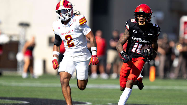 Cincinnati Bearcats wide receiver Caleb Goodie (10) catches a pass and runs for a touchdown as Iowa State Cyclones defensive back Jamison Patton (2) defends in the fourth quarter of the NCAA football game between the Cincinnati Bearcats and Iowa State Cyclones at Nippert Stadium in Cincinnati on Oct. 4, 2025.