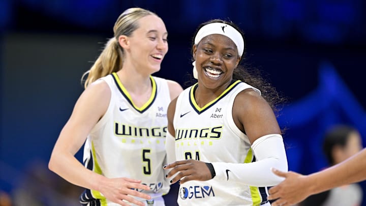 Jul 28, 2025; Arlington, Texas, USA; Dallas Wings guard Paige Bueckers (5) and guard Arike Ogunbowale (24) celebrate during the second half against the New York Liberty at College Park Center. Mandatory Credit: Jerome Miron-Imagn Images