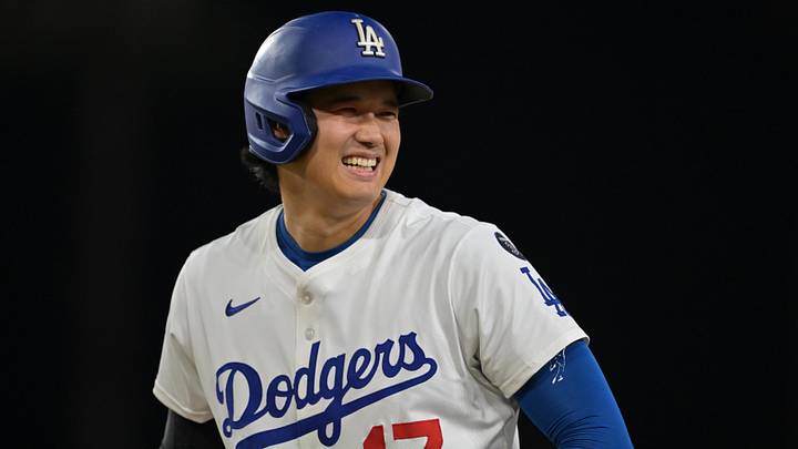 Sep 10, 2025; Los Angeles, California, USA; Los Angeles Dodgers designated hitter Shohei Ohtani (17) smiles after he was awarded first base on catcher interference during the eighth inning against the Colorado Rockies at Dodger Stadium. Mandatory Credit: Jayne Kamin-Oncea-Imagn Images