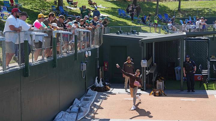 Fans watch from the right field lawn area as San Diego Padres pitcher Jason Adam (lower right) warms up in the bullpen before the game against the Athletics at Sutter Health Park on April 9, 2025. Fans watch from the right field lawn area as San Diego Padres pitcher Jason Adam (lower right) warms up in the bullpen before the game against the Athletics at Sutter Health Park on April 9, 2025.