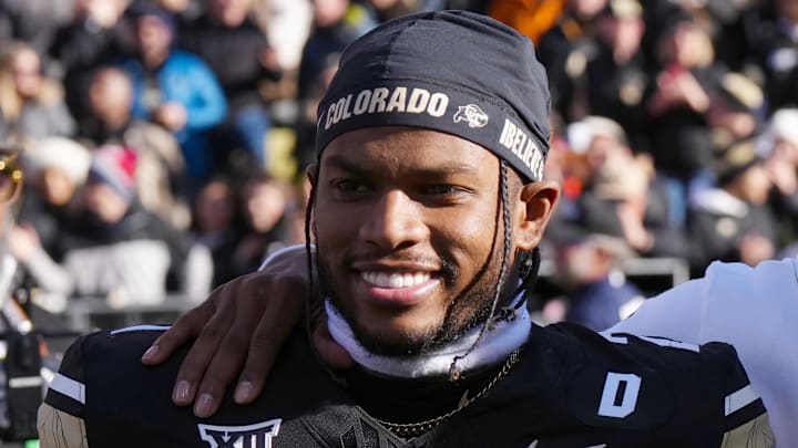 Nov 29, 2024; Boulder, Colorado, USA; Colorado Buffaloes safety Shilo Sanders (21) and head coach Deion Sanders and quarterback Shedeur Sanders (2) and social media producer Deion Sanders Jr. following the win against the Oklahoma State Cowboys at Folsom Field. Mandatory Credit: Ron Chenoy-Imagn Images