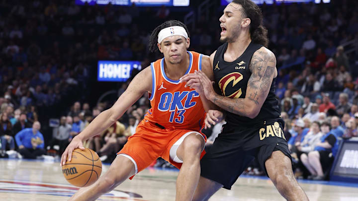 Jan 16, 2025; Oklahoma City, Oklahoma, USA; Oklahoma City Thunder forward Ousmane Dieng (13) moves the ball against Cleveland Cavaliers forward Jaylon Tyson (24) during the fourth quarter at Paycom Center. Mandatory Credit: Alonzo Adams-Imagn Images