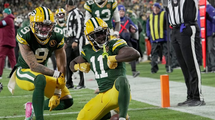 Green Bay Packers wide receiver Jayden Reed (11) celebrates his touchdown reception with wide receiver Christian Watson (9) during the second quarter of their game against the Miami Dolphins Thursday, November 28, 2024 at Lambeau Field in Green Bay, Wisconsin.