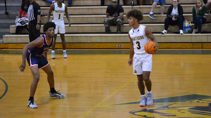 Lecanto's Braylen Moore dribbles against the defense of Vanguard's Brenden Barber during Wednesday night's District 5A-5 semifinal. 