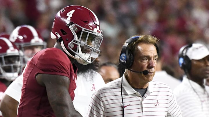 Sep 2, 2023; Tuscaloosa, Alabama, USA;  Alabama Crimson Tide quarterback Jalen Milroe (4) shakes hands with head coach Nick Saban after throwing a touchdown pass against the Middle Tennessee Blue Raiders during the second half at Bryant-Denny Stadium. Alabama won 56-7. Mandatory Credit: Gary Cosby Jr.-Imagn Images