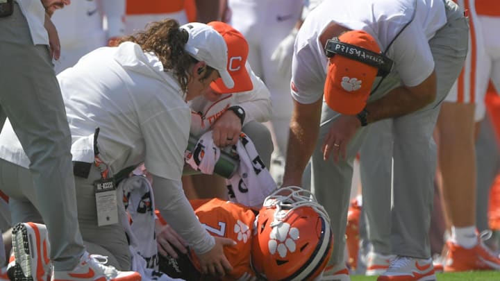 Sep 21, 2024; Clemson, South Carolina, USA; Clemson Tigers running back Phil Mafah (7) is examined by trainers and head coach Dabo Swinney after suffering an apparent injury against the North Carolina State Wolfpack during the first quarter at Memorial Stadium. Mandatory Credit: Ken Ruinard-Imagn Images