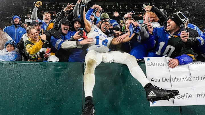 Detroit Lions wide receiver Amon-Ra St. Brown (14) leaps into Lions fans as they celebrate 24-14 win over Green Bay Packers at Lambeau Field in Green Bay, Wis. on Sunday, Nov. 3, 2024.