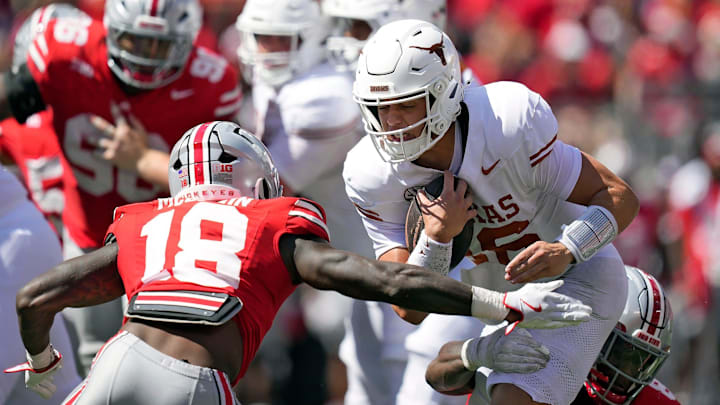 Aug 30, 2025; Columbus, Ohio, USA; Ohio State Buckeyes safety Jaylen McClain (18) tries to tackle Texas Longhorns quarterback Arch Manning (16) in the fourth quarter at Ohio Stadium. Mandatory Credit: Kyle Robertson - Imagn Images