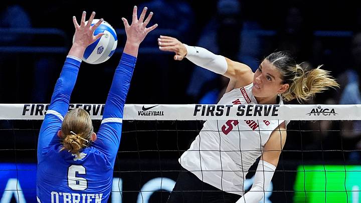 Kentucky Wildcats setter Kassie O'Brien (6) blocks the attack from Wisconsin Badgers outside hitter Eva Travis (5) during the third set of their match at the AVCA First Serve event at Fiserv Forum in Milwaukee, Wisconsin on Aug. 21, 2026.