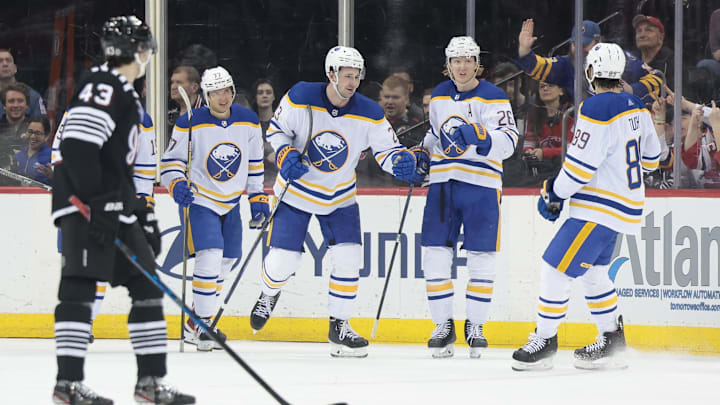 Buffalo Sabres defenseman Mattias Samuelsson (23) celebrates his goal in front of New Jersey Devils defenseman Luke Hughes (43): Vincent Carchietta-Imagn Images