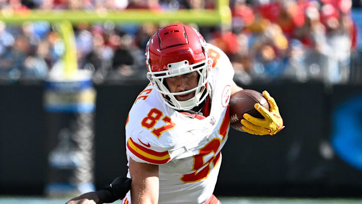 Nov 24, 2024; Charlotte, North Carolina, USA; Kansas City Chiefs tight end Travis Kelce (87) with the ball as Carolina Panthers cornerback Michael Jackson (2) defends in the first quarter at Bank of America Stadium. Mandatory Credit: Bob Donnan-Imagn Images