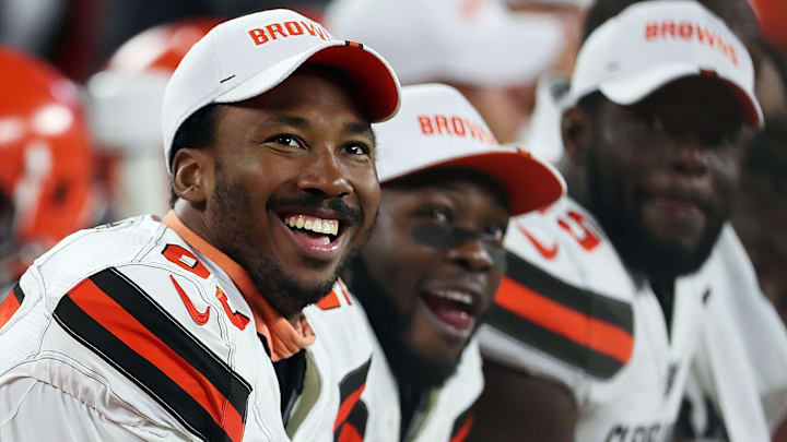 Cleveland Browns defensive end Myles Garrett (left) laughs as he watches a video on the scoreboard during a preseason game against Washington on Aug. 8, 2019, in Cleveland, Ohio.