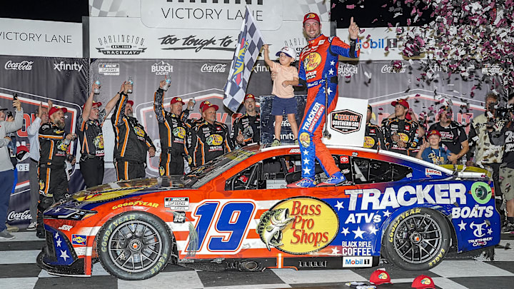 Aug 31, 2025; Darlington, South Carolina, USA;  NASCAR Cup Series driver Chase Briscoe (19) and his son Brooks celebrate his win at the Cookouts Southern 500 at Darlington Raceway.