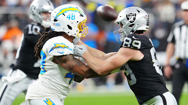 Jan 5, 2025; Paradise, Nevada, USA; Las Vegas Raiders tight end Brock Bowers (89) blocks Los Angeles Chargers linebacker Bud Dupree (48) during the fourth quarter at Allegiant Stadium. Mandatory Credit: Stephen R. Sylvanie-Imagn Images