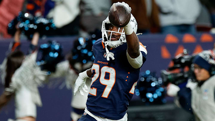 Dec 2, 2024; Denver, Colorado, USA; Denver Broncos cornerback Ja'Quan McMillian (29) celebrates as he scores a touchdown on an interception in the fourth quarter against the Cleveland Browns at Empower Field at Mile High.