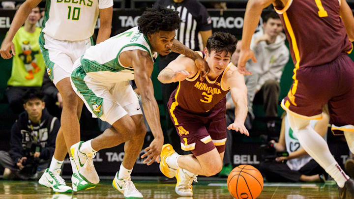 Oregon guard Takai Simpkins, left, and Minnesota forward Bobby Durkin dives after the ball as the Oregon Ducks host the Minnesota Golden Gophers on Feb. 17, 2026, at Matthew Knight Arena in Eugene, Oregon. Oregon guard Takai Simpkins, left, and Minnesota forward Bobby Durkin dives after the ball as the Oregon Ducks host the Minnesota Golden Gophers on Feb. 17, 2026, at Matthew Knight Arena in Eugene, Oregon.