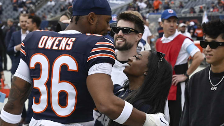 Chicago Bears safety Jonathan Owens and Simone Biles before the game against the Los Angeles Rams at Soldier Field.