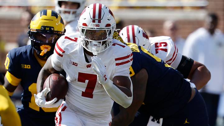 Oct 4, 2025; Ann Arbor, Michigan, USA; Wisconsin Badgers running back Dilin Jones (7) rushes in the first half against the Michigan Wolverines at Michigan Stadium. Mandatory Credit: Rick Osentoski-Imagn Images Oct 4, 2025; Ann Arbor, Michigan, USA; Wisconsin Badgers running back Dilin Jones (7) rushes in the first half against the Michigan Wolverines at Michigan Stadium. Mandatory Credit: Rick Osentoski-Imagn Images