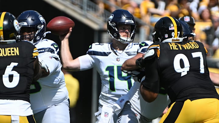 Sep 14, 2025; Pittsburgh, Pennsylvania, USA; Seattle Seahawks quarterback Sam Darnold (14) throws a pass while being pressured by Pittsburgh Steelers defensive tackle Cameron Heyward (97) during the first quarter at Acrisure Stadium. Mandatory Credit: Barry Reeger-Imagn Images